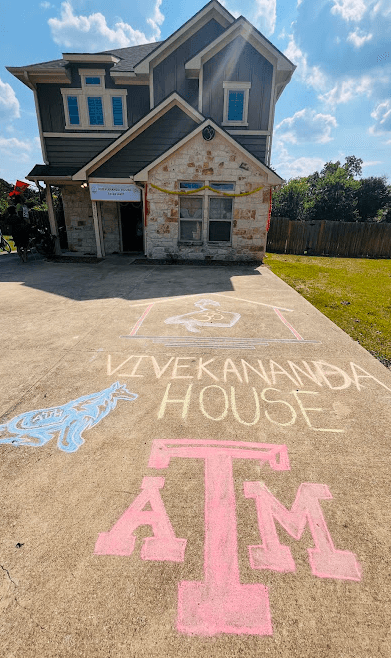 The Texas A&M house, its name chalked across the driveway on move-in day