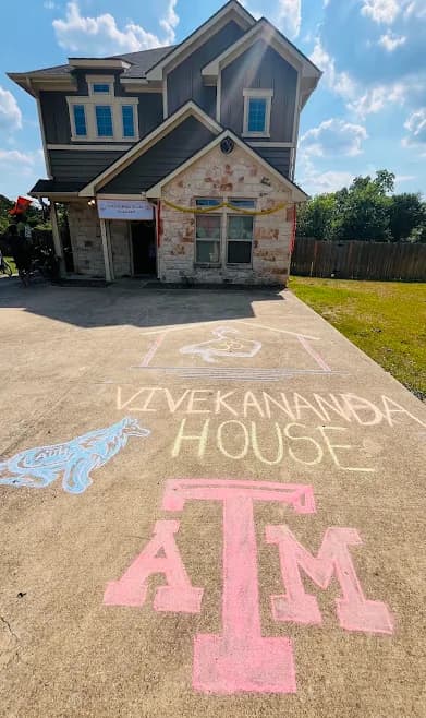 The Texas A&M house, its name chalked across the driveway on move-in day